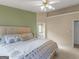 Spacious main bedroom featuring a large bed and an ensuite bathroom with neutral wall colors at 105 Lantana Dr, Locust Grove, GA 30248