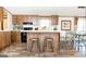 Kitchen featuring cabinets, island with stools, countertops, and hardwood floors at 54 Holly Dr, Carrollton, GA 30116