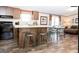 Modern kitchen with wood cabinets, granite countertops and adjacent dining area at 54 Holly Dr, Carrollton, GA 30116