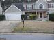 Charming two-story home with a two-car garage, front porch, and manicured lawn at 888 Shadow Lakes Dr, Lithonia, GA 30058