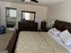 Spacious main bedroom features a large bed, dresser, and access to an ensuite bathroom with tub at 888 Shadow Lakes Dr, Lithonia, GA 30058
