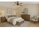 A staged bedroom with a bed, bench and a chair at 7112 Brookview Way, Riverdale, GA 30274