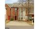 Brick townhouse with a concrete driveway and a large window at 7112 Brookview Way, Riverdale, GA 30274