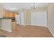 Kitchen and dining area featuring hardwood floors, cabinets, and white appliances at 7112 Brookview Way, Riverdale, GA 30274