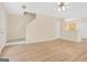Open-concept living area with hardwood floors and stairs to the upper level at 7112 Brookview Way, Riverdale, GA 30274
