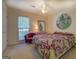 A cozy bedroom features a patterned bedspread, purple chair, and artwork at 2340 Rolling Acres Sw Dr, Conyers, GA 30094