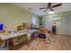 Large bonus room with wood-look floors and ceiling fan at 2340 Rolling Acres Sw Dr, Conyers, GA 30094