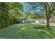 Well-maintained single-story home with a lush front yard and mature trees offering shade at 2340 Rolling Acres Sw Dr, Conyers, GA 30094