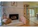 Stone fireplace with glass doors and hearth, plus hardwood flooring, and neutral colors at 2340 Rolling Acres Sw Dr, Conyers, GA 30094