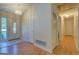 Well-lit foyer with a decorative front door and adjacent hallway at 2340 Rolling Acres Sw Dr, Conyers, GA 30094