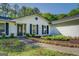 Inviting front entrance highlighted by neat landscaping and blue shutters at 2340 Rolling Acres Sw Dr, Conyers, GA 30094