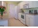 Well-equipped kitchen with white appliances, plenty of counter space and tile flooring at 2340 Rolling Acres Sw Dr, Conyers, GA 30094