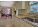 Well-lit kitchen featuring stainless steel sink and ample storage space at 2340 Rolling Acres Sw Dr, Conyers, GA 30094