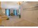 Spacious living area with plush carpeting, natural light, and versatile layout for relaxation at 2340 Rolling Acres Sw Dr, Conyers, GA 30094