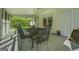 Sunroom features a screen wall, a black metal table set and a white rocking chair at 2340 Rolling Acres Sw Dr, Conyers, GA 30094