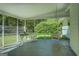 The sunroom with chairs, a hanging bench, and a view of the yard with green trees at 2340 Rolling Acres Sw Dr, Conyers, GA 30094
