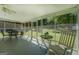 Sunroom features a screen wall, a black metal table set and a white rocking chair at 2340 Rolling Acres Sw Dr, Conyers, GA 30094