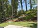 Overlooking a green backyard with a lush lawn and a peaceful, wooded backdrop at 3383 Milan Ct # 4 Plapprox Sqft 1, Douglasville, GA 30135