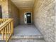 Covered front porch with brick wall and wood railing at entrance to home at 3383 Milan Ct # 4 Plapprox Sqft 1, Douglasville, GA 30135