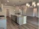 Open kitchen and living space with granite countertops, hardwood flooring, and modern lighting at 3383 Milan Ct # 4 Plapprox Sqft 1, Douglasville, GA 30135