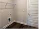 Bright laundry room with modern flooring, gray walls, and a wire rack shelf above the washer/dryer hookups at 3383 Milan Ct # 4 Plapprox Sqft 1, Douglasville, GA 30135