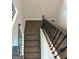 A top-down view of a staircase with black wrought iron railings and carpeted steps at 3383 Milan Ct # 4 Plapprox Sqft 1, Douglasville, GA 30135