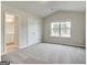 Spacious bedroom with ensuite bathroom, closet, carpet, and lots of natural light at 300 San Anselmo St, Locust Grove, GA 30248