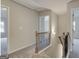 Upstairs hallway featuring wood and iron railing with access to the bedrooms at 300 San Anselmo St, Locust Grove, GA 30248