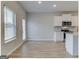Bright eat-in kitchen with white cabinets, stainless appliances, and hardwood floors at 300 San Anselmo St, Locust Grove, GA 30248