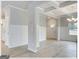 Bright living room with coffered ceiling, wainscoting, and access to kitchen at 300 San Anselmo St, Locust Grove, GA 30248