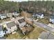 An aerial view of a suburban neighborhood showing charming homes and tree-lined streets in autumn at 103 Watercress Ct, Stockbridge, GA 30281