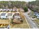 The home's aerial view showcasing the backyard, shed, and the surrounding neighborhood with tree lined greenery at 103 Watercress Ct, Stockbridge, GA 30281
