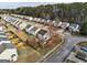 An aerial view of a backyard and surrounding neighborhood with tree lined street and greenery at 103 Watercress Ct, Stockbridge, GA 30281