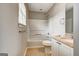 Bathroom with vanity and tub, with wood-look flooring and bright vanity lighting at 103 Watercress Ct, Stockbridge, GA 30281