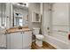 Bathroom with vanity and tub, with wood-look flooring and bright vanity lighting at 103 Watercress Ct, Stockbridge, GA 30281