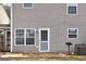 A well-maintained backyard with a fenced in yard and cozy back door and stone patio for outside lounging at 103 Watercress Ct, Stockbridge, GA 30281
