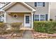 The front of the home has manicured landscaping and a classic front door at 103 Watercress Ct, Stockbridge, GA 30281