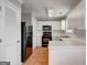 Kitchen featuring white cabinets, black appliances, and tile flooring at 103 Watercress Ct, Stockbridge, GA 30281
