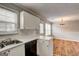 Open kitchen with white cabinets, stainless sink, and access to dining area at 103 Watercress Ct, Stockbridge, GA 30281