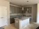 Well-lit kitchen featuring gray cabinets, granite countertops, and a central island at 5301 Tolar Rd # 95, South Fulton, GA 30213