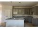 Modern kitchen with gray cabinets, granite countertops, and a stylish center island at 5301 Tolar Rd # 95, South Fulton, GA 30213