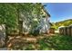 A view of the backyard with shade trees, partial fencing, and a shed at 131 Turning Pt, Stockbridge, GA 30281