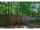 View of a wooden backyard fence providing privacy with natural surroundings in this wooded area at 131 Turning Pt, Stockbridge, GA 30281