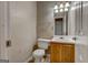 Compact bathroom with a toilet, sink, vanity, and lighting fixture, awaiting updates for added comfort at 131 Turning Pt, Stockbridge, GA 30281