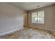 Bedroom with a large window offering natural light, poised for renovation to become a cozy retreat at 131 Turning Pt, Stockbridge, GA 30281