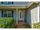 A welcoming doorway featuring an oval-shaped window, classic columns, and views of the front yard at 131 Turning Pt, Stockbridge, GA 30281