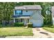 Two-story home featuring charming blue shutters, an attached garage, and a well-maintained lawn at 131 Turning Pt, Stockbridge, GA 30281