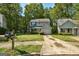 Home with green lawn, driveway, mailbox, mature trees, and traditional architectural details at 131 Turning Pt, Stockbridge, GA 30281
