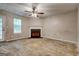 A spacious living room features a ceiling fan, a fireplace, and natural lighting at 131 Turning Pt, Stockbridge, GA 30281