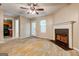 An open living room features a fireplace, ceiling fan, and access to the backyard with natural light at 131 Turning Pt, Stockbridge, GA 30281